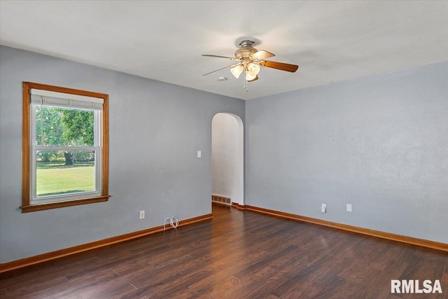 2912 E Enos Ave, Springfield, IL 62702 - empty room featuring arched walkways, dark wood-type flooring, and ceiling fan