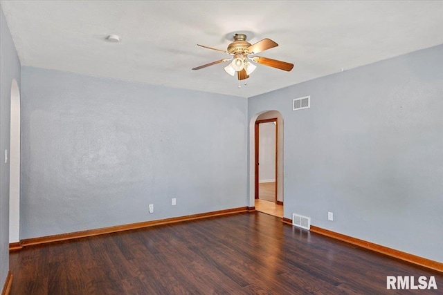 2912 E Enos Ave, Springfield, IL 62702 - empty room featuring arched walkways, wood finished floors, a ceiling fan, and a smoke detector