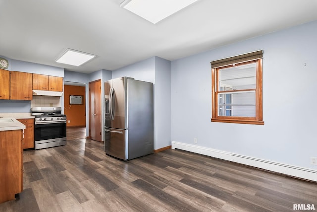 113 W Walnut St, Chatham, IL 62629 - kitchen featuring stainless steel appliances, baseboard heating, under cabinet range hood, light countertops, and dark wood finished floors