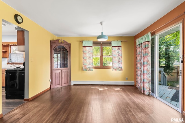 113 W Walnut St, Chatham, IL 62629 - unfurnished dining area with a baseboard radiator and wood finished floors