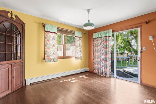 113 W Walnut St, Chatham, IL 62629 - unfurnished dining area featuring a baseboard radiator, wood finished floors, and healthy amount of natural light