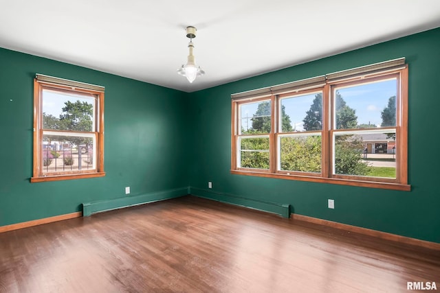 113 W Walnut St, Chatham, IL 62629 - unfurnished room featuring wood finished floors and a baseboard radiator