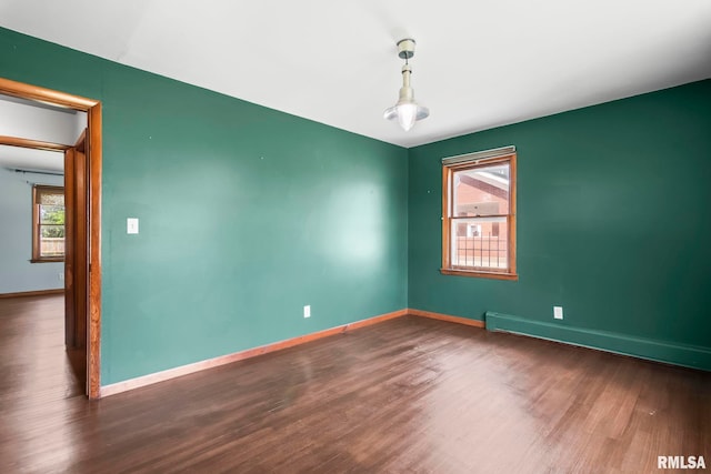 113 W Walnut St, Chatham, IL 62629 - unfurnished room with wood finished floors and a baseboard radiator