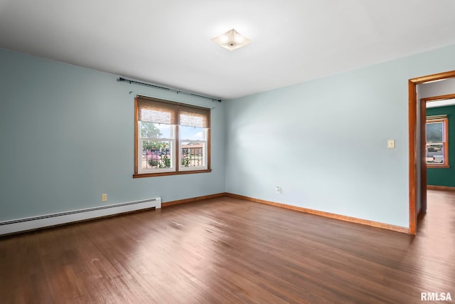 113 W Walnut St, Chatham, IL 62629 - spare room featuring wood finished floors and a baseboard heating unit