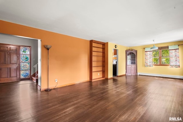 113 W Walnut St, Chatham, IL 62629 - unfurnished living room featuring a baseboard radiator, wood finished floors, and stairs