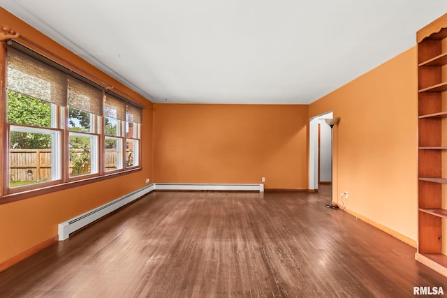 113 W Walnut St, Chatham, IL 62629 - spare room featuring baseboard heating and wood finished floors