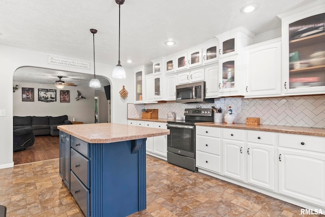 16540 Wernowsky St, Petersburg, IL 62675 - kitchen featuring appliances with stainless steel finishes, arched walkways, blue cabinetry, stone finish floors, and recessed lighting