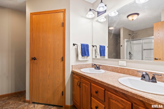 16540 Wernowsky St, Petersburg, IL 62675 - bathroom featuring a shower stall, double vanity, and a textured ceiling