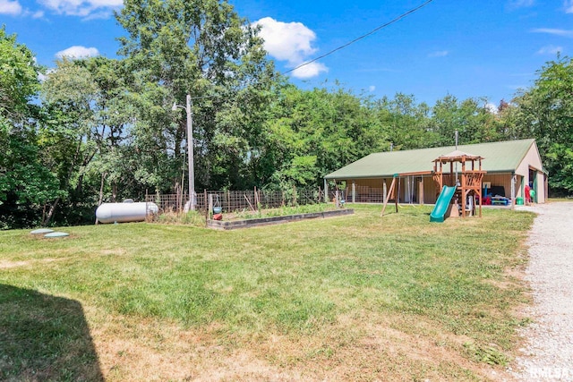 16540 Wernowsky St, Petersburg, IL 62675 - view of yard featuring a playground, a detached garage, and view of wooded area