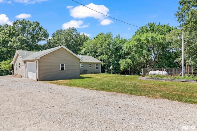 16540 Wernowsky St, Petersburg, IL 62675 - view of home's exterior with a garage, dirt driveway, and view of scattered trees