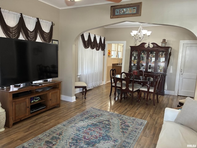 700 S 20th St, Quincy, IL 62301 - living room featuring arched walkways, crown molding, a chandelier, and wood finished floors