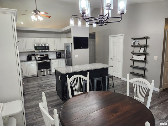 2302 Knoxville Dr, Springfield, IL 62711 - dining area with a chandelier, dark wood-style floors, and ceiling fan