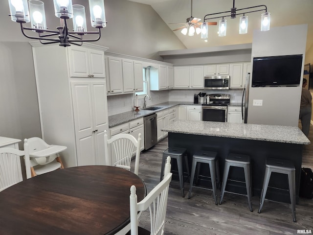 2302 Knoxville Dr, Springfield, IL 62711 - kitchen featuring stainless steel appliances, a chandelier, a ceiling fan, dark wood-style flooring, and white cabinetry
