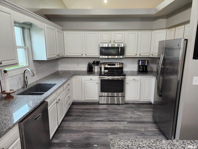 2302 Knoxville Dr, Springfield, IL 62711 - kitchen with stainless steel appliances, white cabinetry, dark wood-style floors, and backsplash