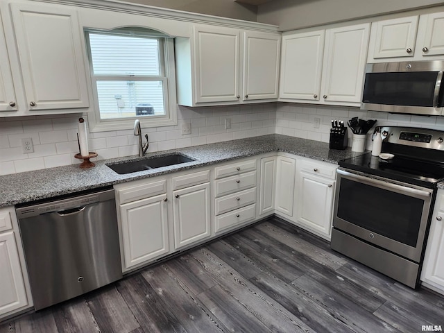 2302 Knoxville Dr, Springfield, IL 62711 - kitchen featuring appliances with stainless steel finishes, white cabinets, dark wood-type flooring, and backsplash