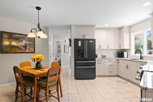 4905 Eagles Lndg, Springfield, IL 62711 - kitchen featuring black fridge, light stone counters, hanging light fixtures, light tile patterned floors, and recessed lighting