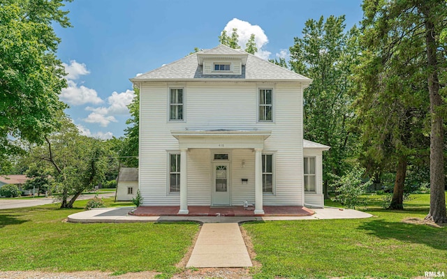 418 E Cooke St, Mount Pulaski, IL 62548 - view of front of home featuring a front yard, covered porch, and a shingled roof