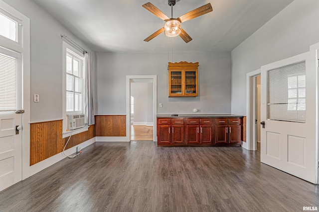 418 E Cooke St, Mount Pulaski, IL 62548 - unfurnished living room featuring a ceiling fan, dark wood-type flooring, cooling unit, and a wainscoted wall