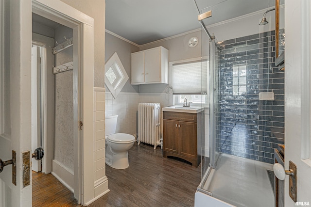 418 E Cooke St, Mount Pulaski, IL 62548 - bathroom featuring radiator, a shower stall, wood finished floors, crown molding, and vanity