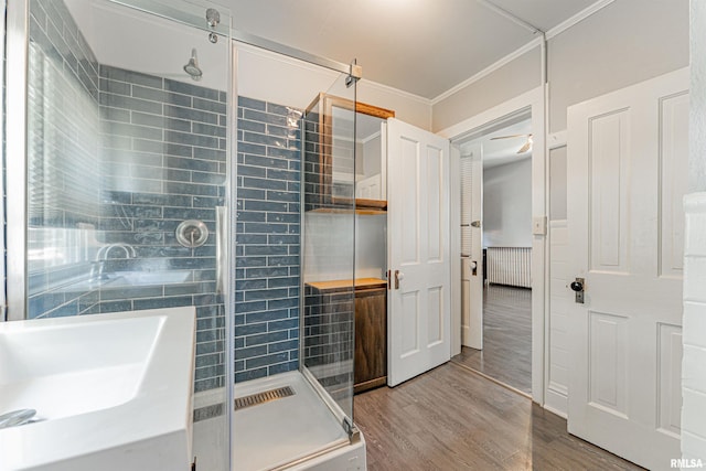 418 E Cooke St, Mount Pulaski, IL 62548 - bathroom featuring a shower stall, wood finished floors, ornamental molding, and a ceiling fan