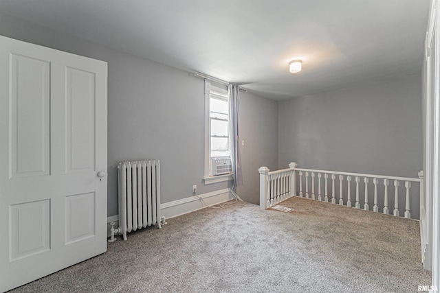 418 E Cooke St, Mount Pulaski, IL 62548 - carpeted empty room with radiator and cooling unit