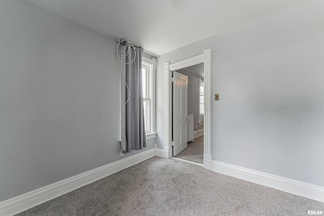 418 E Cooke St, Mount Pulaski, IL 62548 - spare room featuring carpet and baseboards