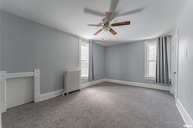 418 E Cooke St, Mount Pulaski, IL 62548 - spare room featuring radiator heating unit, ceiling fan, and carpet