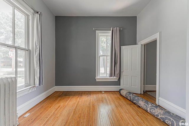418 E Cooke St, Mount Pulaski, IL 62548 - empty room featuring radiator and wood finished floors