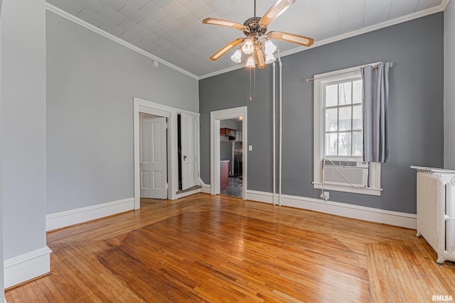 418 E Cooke St, Mount Pulaski, IL 62548 - spare room with crown molding, cooling unit, radiator heating unit, hardwood / wood-style flooring, and a ceiling fan