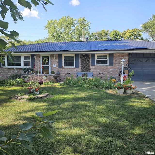 704 N Cherry St, Abingdon, IL 61410 - ranch-style house featuring brick siding, an attached garage, a front yard, and a metal roof