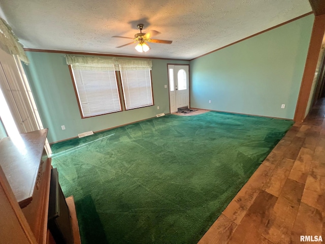 517 S Obannon St, Raymond, IL 62560 - spare room featuring ornamental molding, ceiling fan, hardwood / wood-style flooring, and a textured ceiling