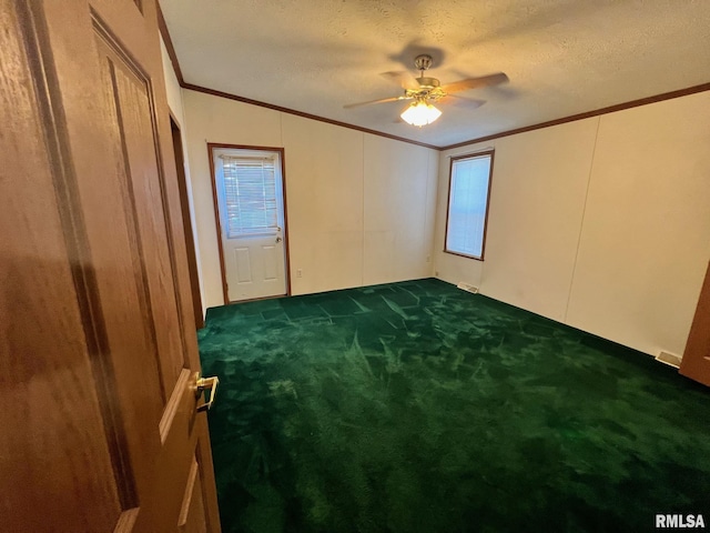 517 S Obannon St, Raymond, IL 62560 - unfurnished bedroom featuring ornamental molding, dark carpet, a textured ceiling, and a ceiling fan