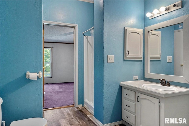 913 Springfield St, Kincaid, IL 62540 - full bathroom featuring vanity, wood finished floors, curtained shower, crown molding, and a textured wall