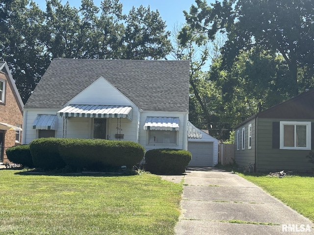 2308 S Whittier Ave, Springfield, IL 62704 - bungalow-style house with roof with shingles, a front yard, and an outbuilding