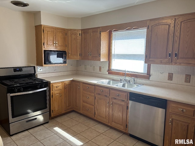 2308 S Whittier Ave, Springfield, IL 62704 - kitchen with appliances with stainless steel finishes, light countertops, decorative backsplash, and light tile patterned flooring