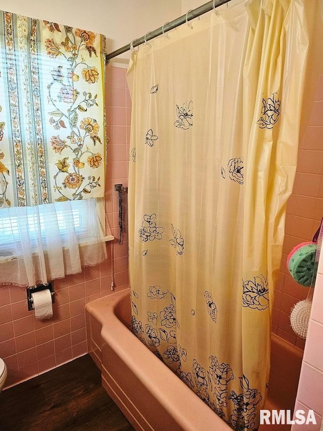 707 E Clark St, Litchfield, IL 62056 - bathroom with shower / bathtub combination with curtain, tile walls, and wood finished floors