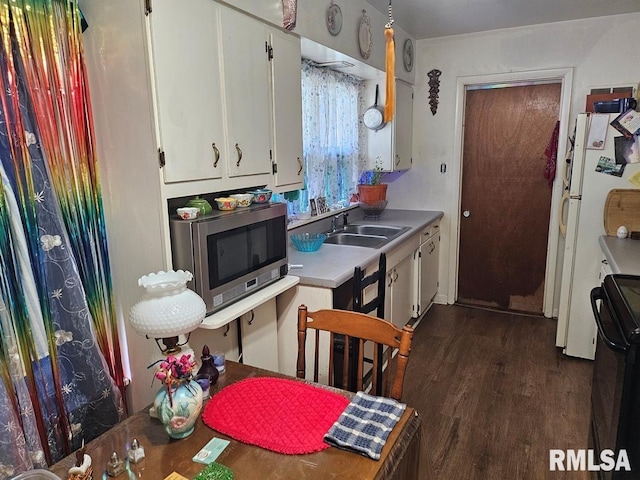 707 E Clark St, Litchfield, IL 62056 - kitchen featuring stainless steel microwave, stove, white cabinetry, light countertops, and dark wood-style floors