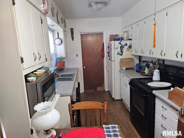 707 E Clark St, Litchfield, IL 62056 - kitchen with black range with electric stovetop, dark wood-style floors, and white cabinets