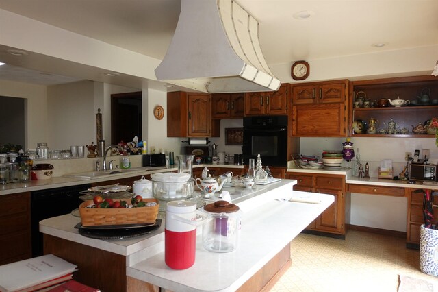 604 Knox Rd N Unit 1000, Gilson, IL 61436 - kitchen with oven, custom exhaust hood, light countertops, a center island, and brown cabinetry