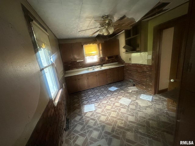 544 W Tompkins St, Galesburg, IL 61401 - kitchen with light stone finish flooring, a ceiling fan, light countertops, brown cabinets, and open shelves