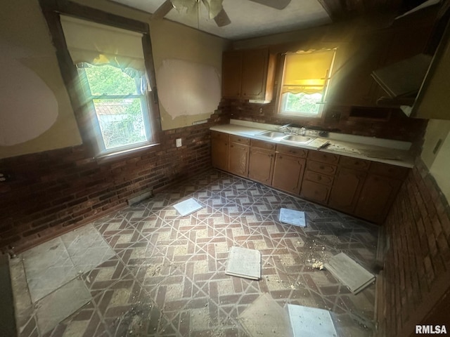 544 W Tompkins St, Galesburg, IL 61401 - kitchen with a ceiling fan, light countertops, brick wall, and light flooring
