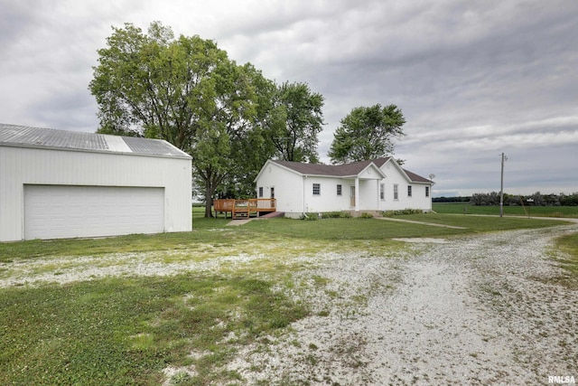 1784 N 2700th Ave, Loraine, IL 62349 - view of side of property with a deck, an outdoor structure, a garage, a yard, and a metal roof
