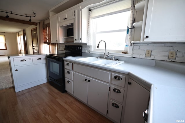 42060 County Highway 10, Nebo, IL 62355 - kitchen with black electric range oven, white cabinets, wood finished floors, and a peninsula