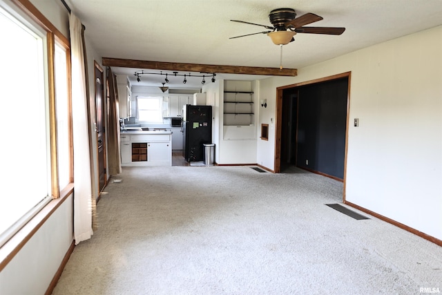 42060 County Highway 10, Nebo, IL 62355 - unfurnished living room with a ceiling fan, light carpet, and track lighting