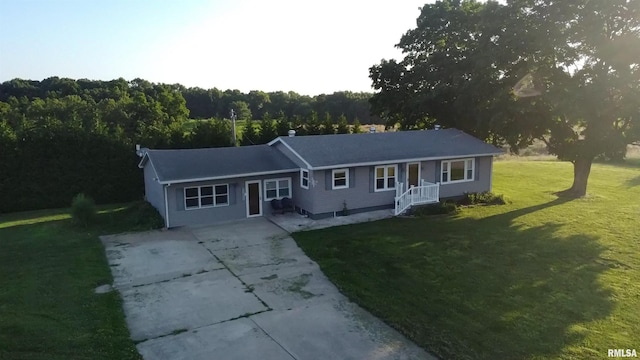 42060 County Highway 10, Nebo, IL 62355 - single story home with concrete driveway, a front yard, and a view of trees