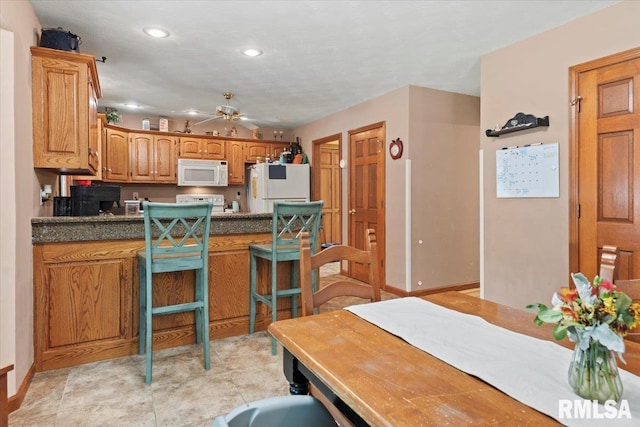1420 Weston Pointe Dr, Springfield, IL 62704 - kitchen with white appliances, recessed lighting, a ceiling fan, a peninsula, and dark countertops