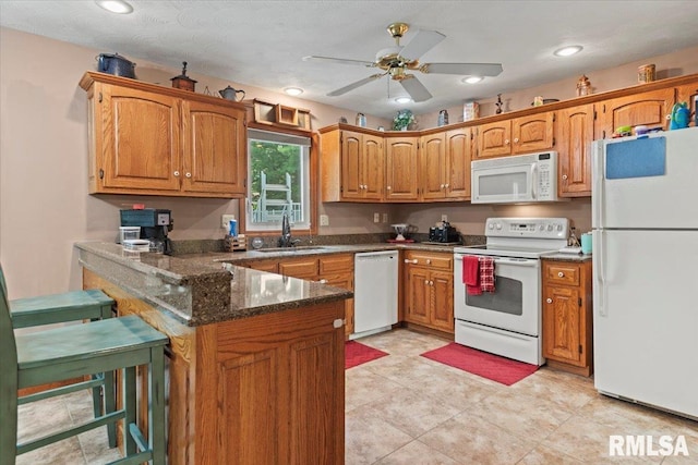 1420 Weston Pointe Dr, Springfield, IL 62704 - kitchen featuring white appliances, a peninsula, ceiling fan, brown cabinetry, and recessed lighting