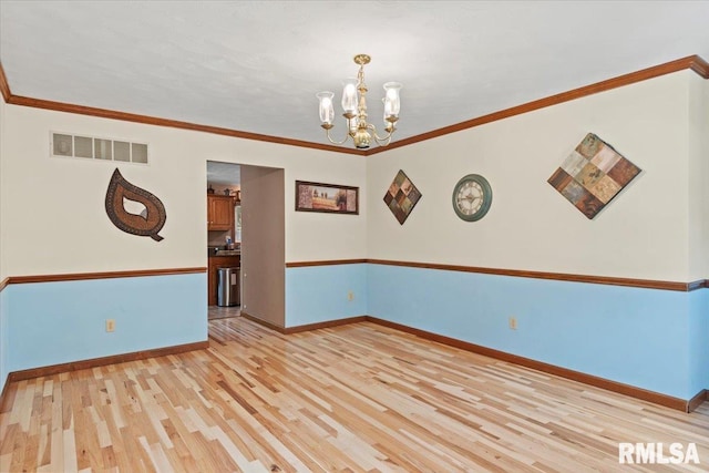 1420 Weston Pointe Dr, Springfield, IL 62704 - spare room with light wood-style floors, a chandelier, and ornamental molding
