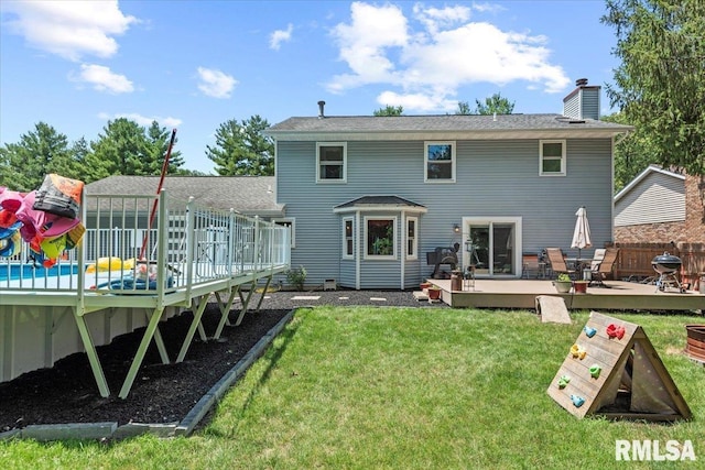 1420 Weston Pointe Dr, Springfield, IL 62704 - rear view of property featuring a deck, a lawn, and a chimney
