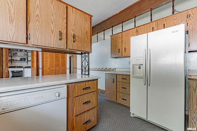 913 N Flora Dr, Mount Pulaski, IL 62548 - kitchen with white appliances, washer and dryer, light countertops, and carpet